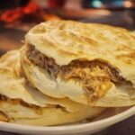 Ancient_Chinese__Meat_Sandwich__Steals_the_Foodie_Spotlight___ - 🌍NewspaperAmigo – Your Global News Buddy 🗞️ __Ancient_Chinese__Meat_Sandwich__Steals_the_Foodie_Spotlight___