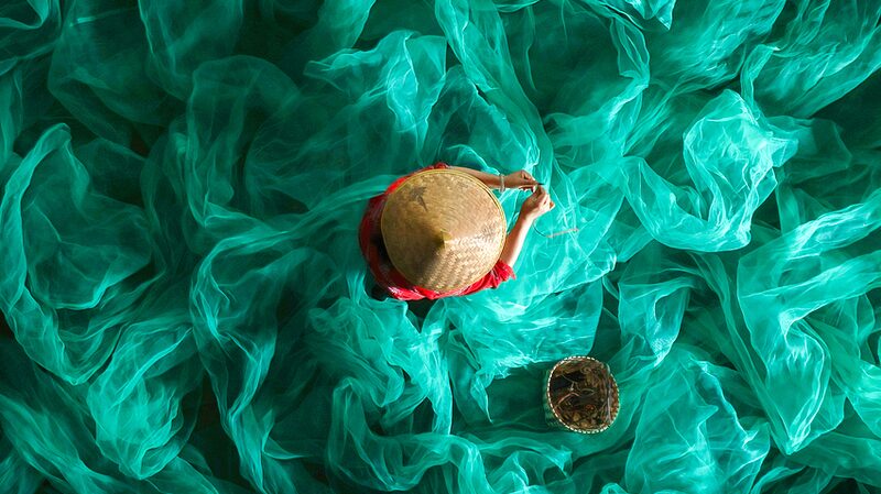 Sea_of_Green__Fisherwoman_s_Net_Mending_Captures_Coastal_Magic___ - 🌍NewspaperAmigo – Your Global News Buddy 🗞️ Sea_of_Green__Fisherwoman_s_Net_Mending_Captures_Coastal_Magic___