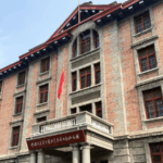 GQ044CF9D8I69HBUPKH7 - 🌍NewspaperAmigo – Your Global News Buddy 🗞️ Beijing's Red Building: Where Revolution Met Modern Thought 🏛️🔥