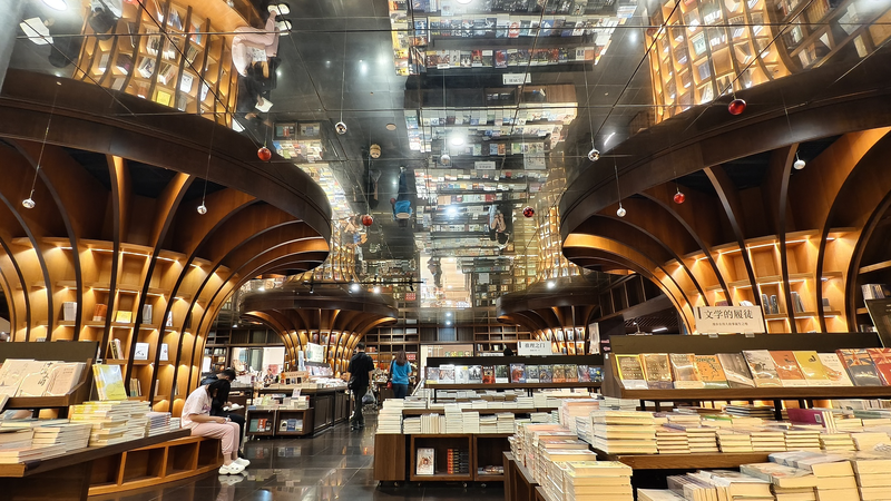 LL24WJ67WG8VULKD4KNP - 🌍NewspaperAmigo – Your Global News Buddy 🗞️ Shanghai's Futuristic Bookstore Becomes Cultural Hotspot 🌧️📚✨