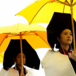 Yi Women’s Yellow Umbrellas Illuminate Ancient Sun Traditions 🌞🌂