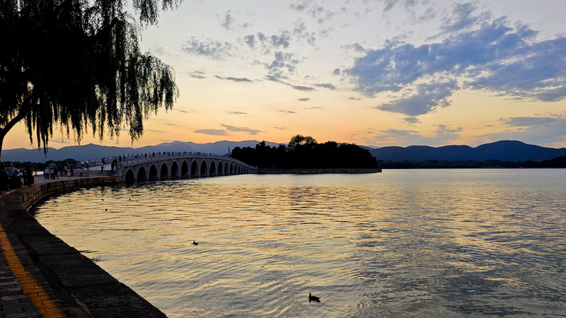 PNF2AWB3S71S1GQ7KGS4 - 🌍NewspaperAmigo – Your Global News Buddy 🗞️ Beijing's Summer Palace Glows in Stunning Sunset Spectacle 🌅✨