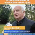 SXQ2LZEM3WVXZAYO2BKR - 🌍NewspaperAmigo – Your Global News Buddy 🗞️ German Analyst Slams US Over Middle East Crisis: 'A Joke' 🌍⚖️ video poster